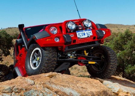 OME 4 inch Lift Kit installed of a red Jeep Wrangler JK 2007-2015 another view