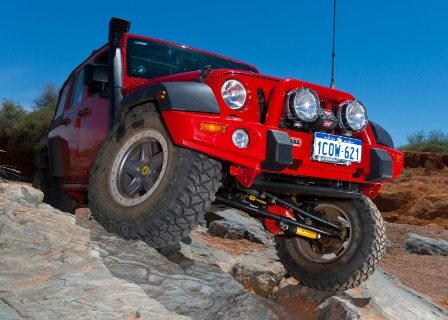 OME 4 inch Lift Kit installed of a red Jeep Wrangler JK 2007-2015