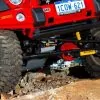 OME 4 inch Lift Kit installed of a red Jeep Wrangler JK 2007-2015 front close up